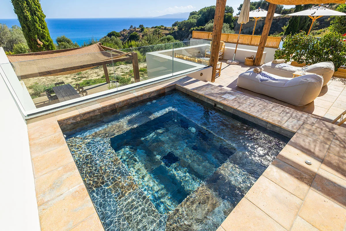 Private plunge pool with sea views and sun loungers at Eliamos luxury resort in Kefalonia, Greece.